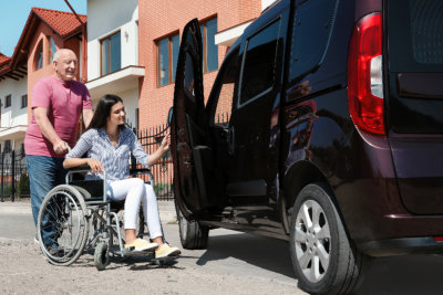 young woman together with her carer preparing to board on a van