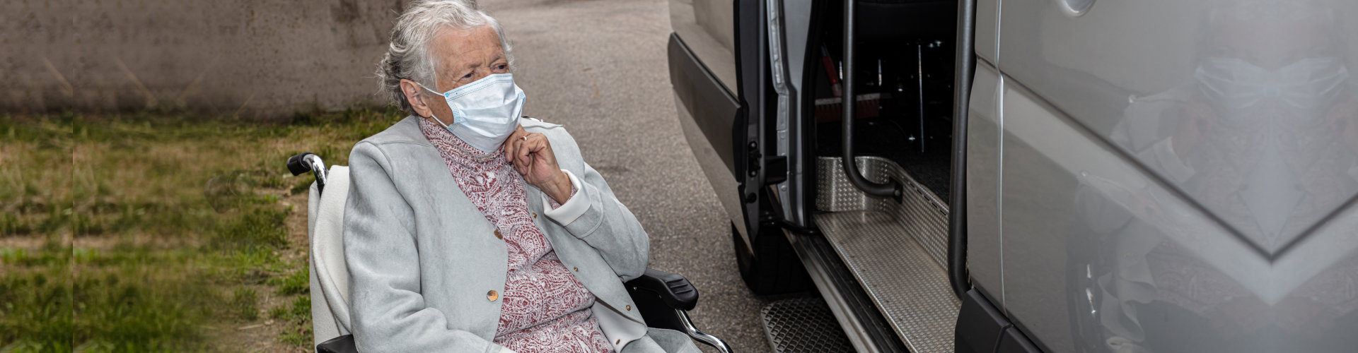 elderly woman preparing to board on a van
