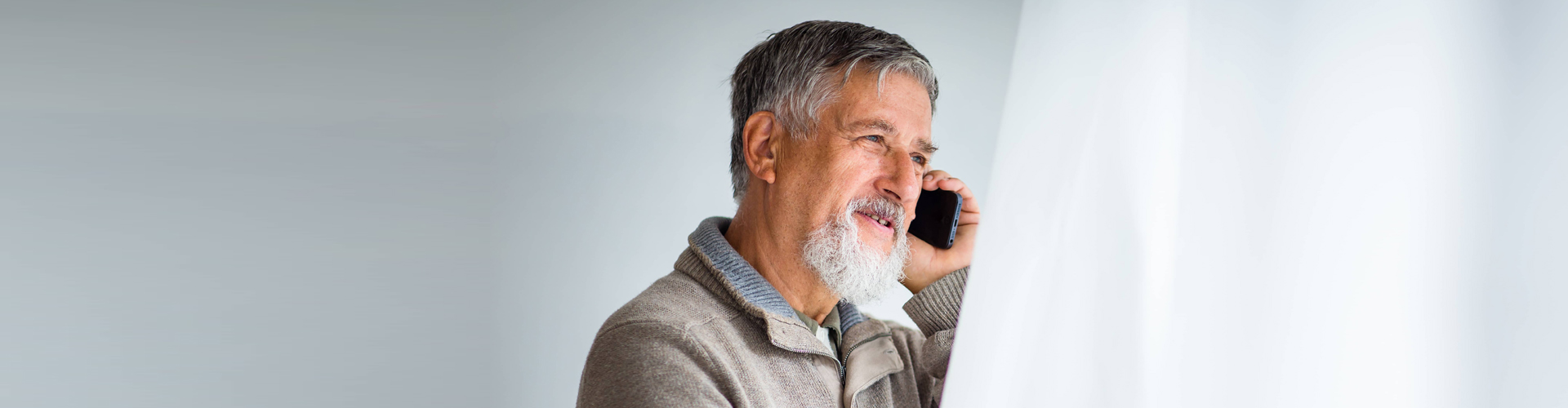 elderly man answering a phone call